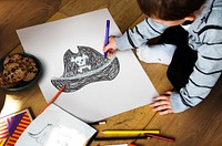 Child with a drawing of pirate hat