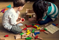 Children having fun playing toy blocks