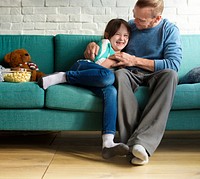 A father having a fun time playing with his daughter 