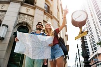 Couple looking for directions using the map they are holding