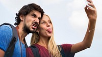 Couple taking a wacky selfie tongue out