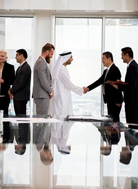 Middle eastern business man having a hand shake with an Asian businessman
