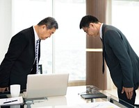 Japanese businessmen shows respect to each other by bowing