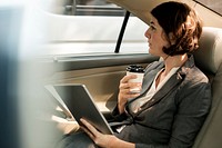 Businesswoman Using Tablet Car Inside