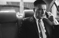 Businessman Talking Using Phone Car Inside
