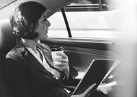 Businesswoman Using Tablet Car Inside