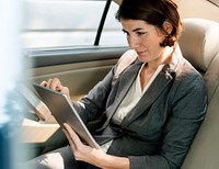 Businesswoman Using Tablet Car Inside