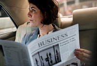 Businesswoman Reading Newspaper Car Inside