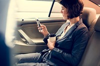 Businesswoman Using Smart Phone Car Inside