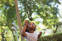 African kid playing with bubbles