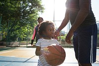 Father playing basketball with his child