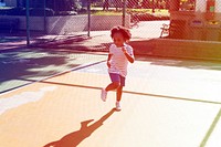 Little african girl exercise on the court
