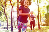 African girl running in the park with family