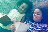 Little Girls Lay On The Floor Reading Book Sisterhood