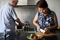 Elderly couple cooking together