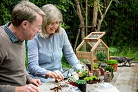 Elderly senior couple gardening together 