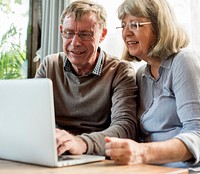 Old couple using laptop together