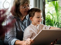 Grandmother and grandson reading a book together