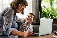 Grandmother and grandson using the laptop together