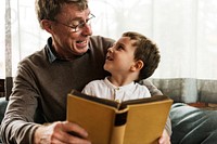 Grandfather and grandson reading a book together