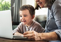 Grandmother and grandson using the laptop together