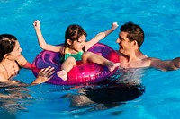 Mixed family enjoying summer pool time