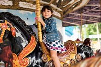 Little girl on a carousel horse