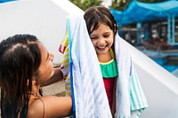 Mom drying his daughter with a towel