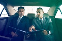 Businessmen explaining about report in the car