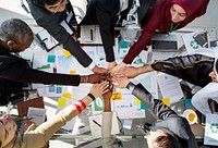 A Group of Business People Putting Hands Together in a Meeting