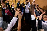 A Group of International Business People Are Raising Their Hands
