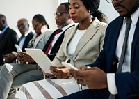 A Group of International Business People Are Sitting and Using Tablet and Mobile Devices