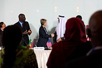 A Group of Business People Participating in a Panel Discussion  Are Greeting One Another 