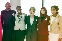Diverse team together with pink ribbon