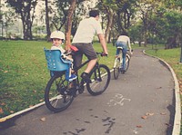 Family riding bicycle in the park on holiday