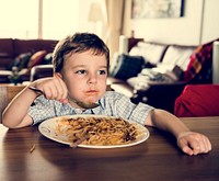 Boy eating a plate of spaghetti