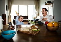 Father and son having fun at the breakfast table