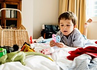 A boy and birthday candle in a bedroom.