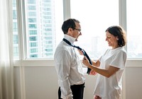 Wife helping to tie husbands tie