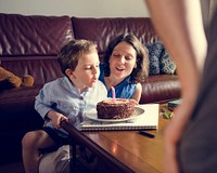 Family celebrate birthday party with chocolate cake