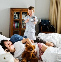 Boy Awakening Dad and Mom in the Bebroom