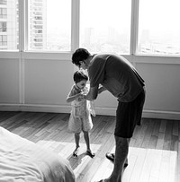 Father helping son to get dressed