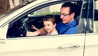 Dad teaching his boy to drive