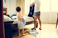 Father and son dressing their clothes in hurry and rush