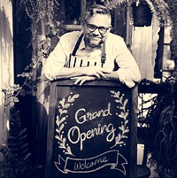 Adult Man Standing with Grand Opening Sign