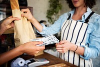 Customer Buying Fresh Baked Bread in Bakery Shop