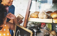 Customer Buying Fresh Baked Bread in Bakery Shop