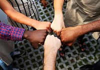 Diversity hands fist bumped together teamwork