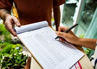 Closeup of hand signing on delivery paper