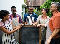 Group of diverse people with blank chalkboard